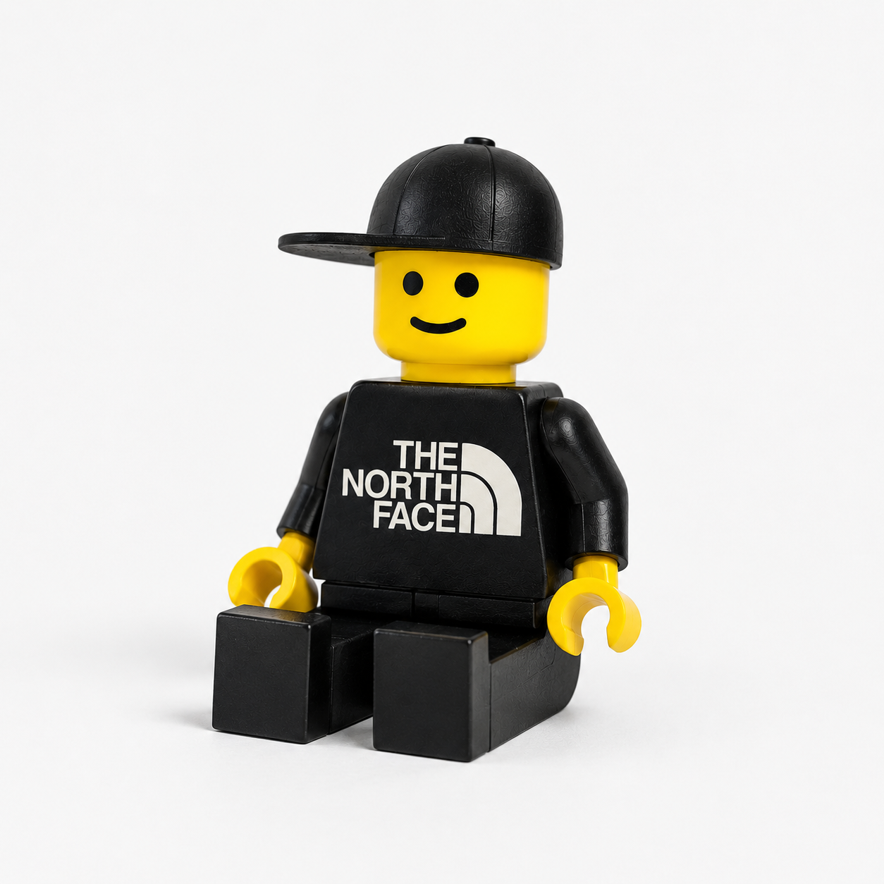 LEGO minifigure wearing a black shirt with 'The North Face' logo on a white background