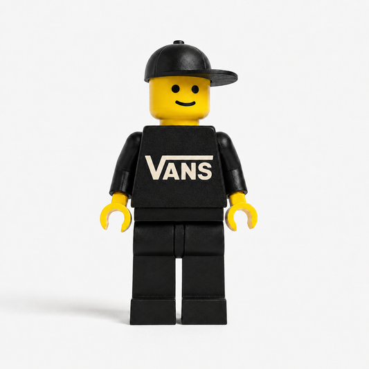 LEGO minifigure wearing a black cap and black shirt with 'VANS' logo on a white background